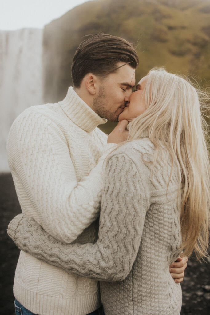 kiss in front of skogafoss waterfall