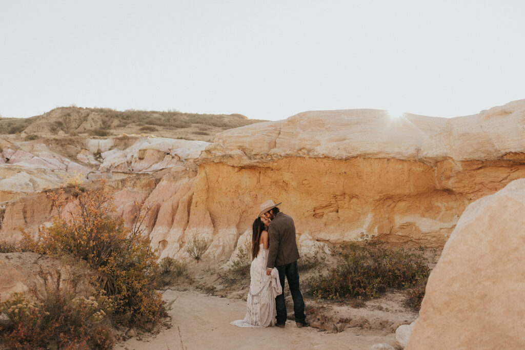 stunning couple kissing in paint mines during their beautiful boho elopement  | Andrew & Chelsey's Beautiful Boho Elopement in Paint Mines, Colorado