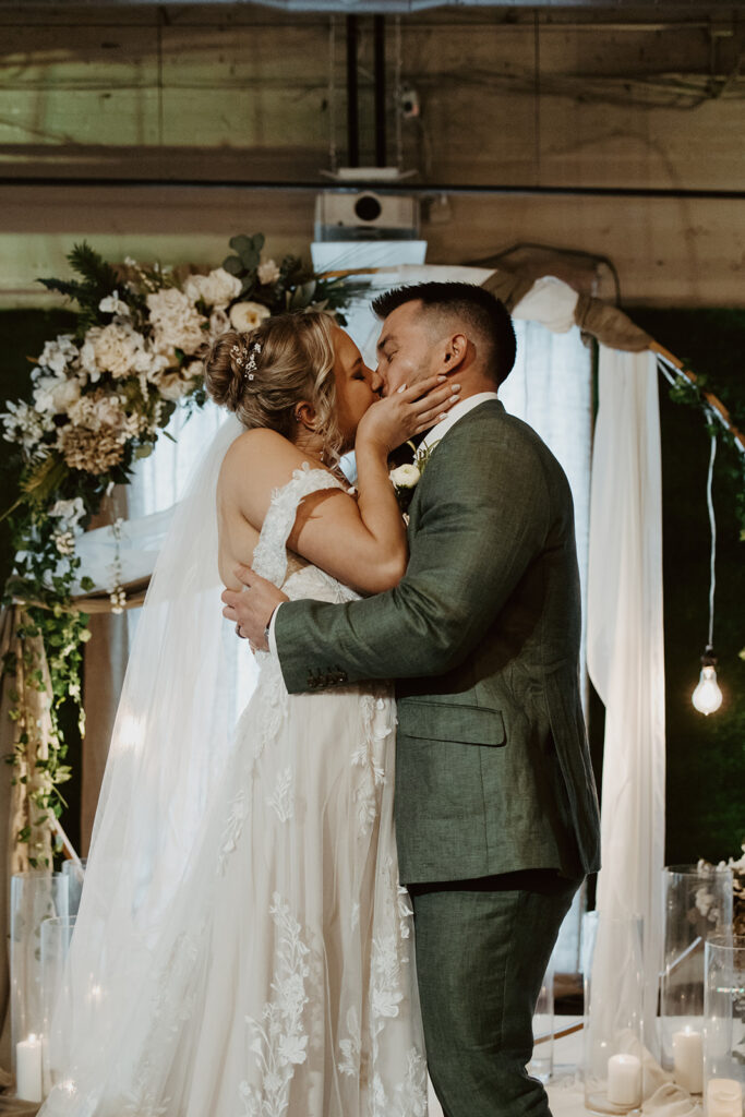 bride and groom during their first kiss