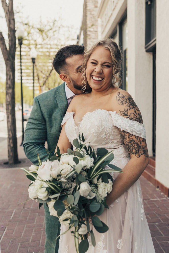 bride and groom posing for wedding portraits