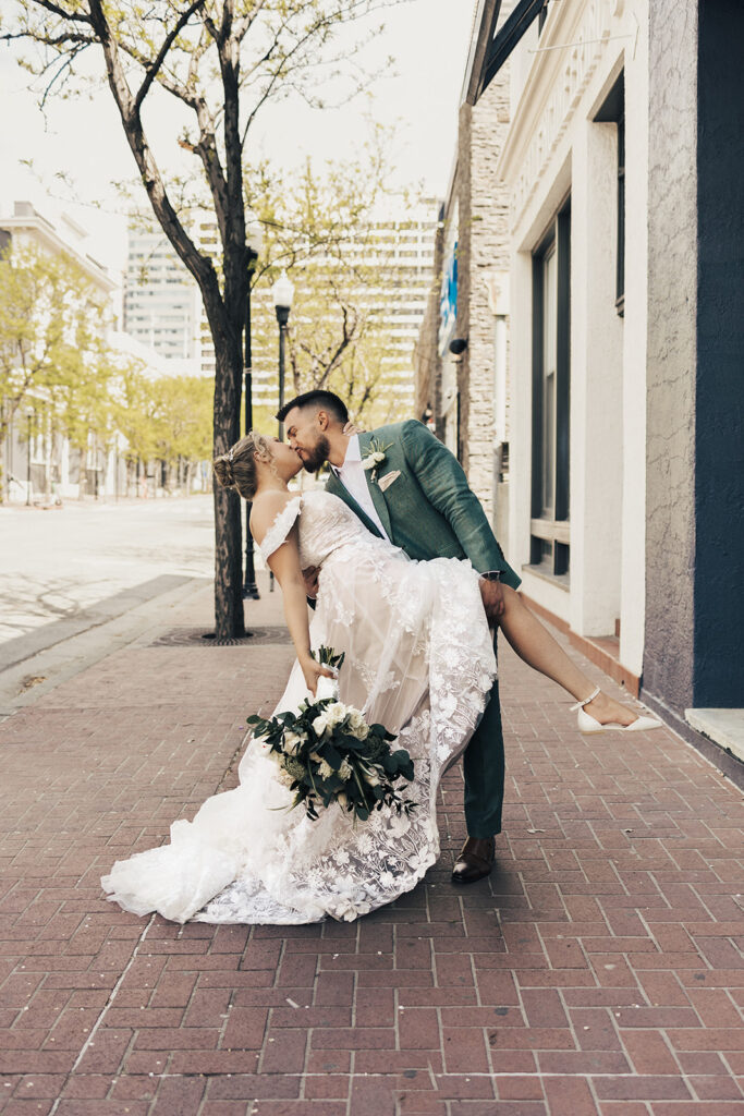 bride and groom posing on the street for their wedding photos - salt lake city wedding