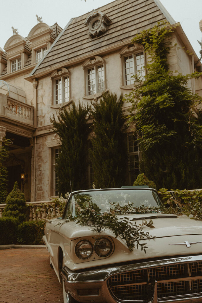 couple posing in front of their wedding venue in utah
