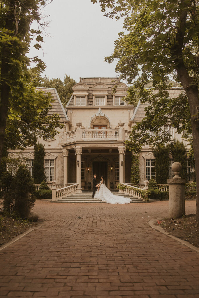 couple posing in front of their wedding venue in utah
