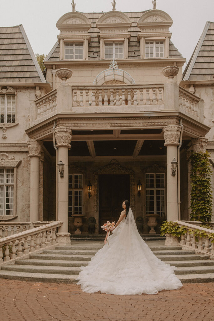 couple posing in front of their wedding venue in utah