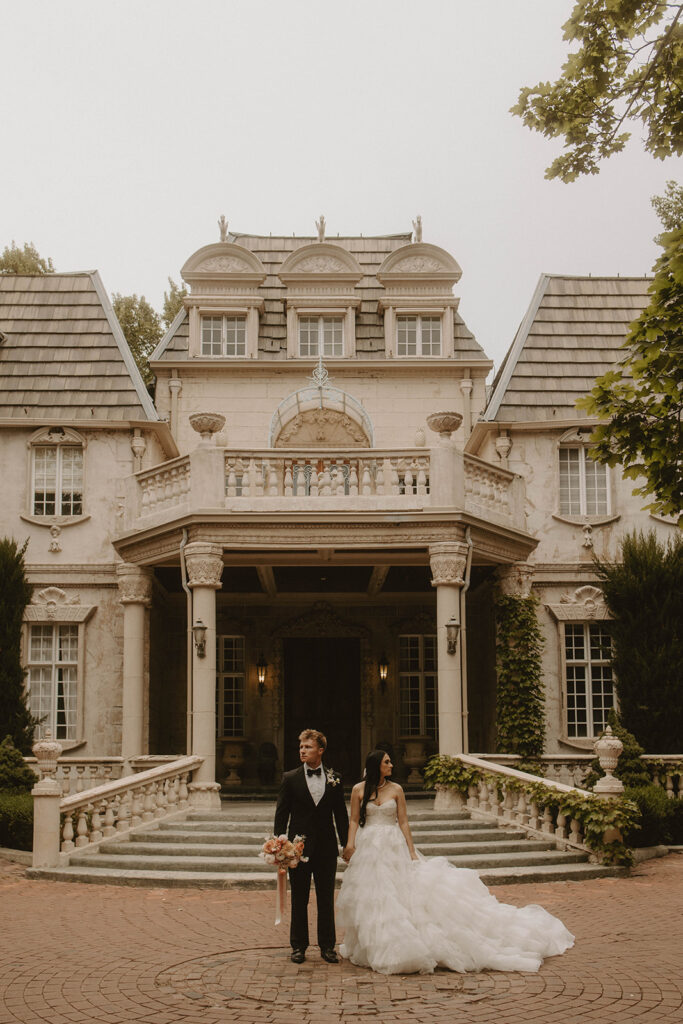 couple posing in front of their wedding venue in utah
