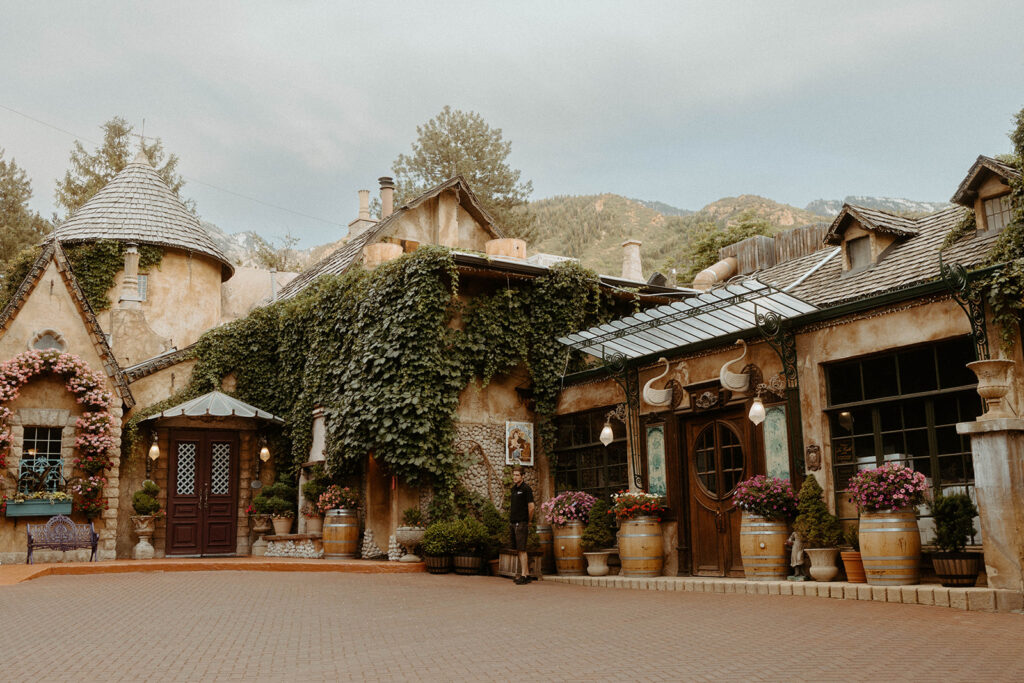 couple posing in front of their wedding venue in utah
