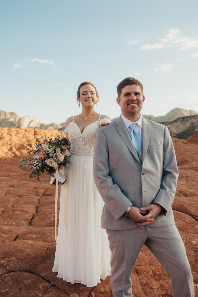 Couple posing for their wedding photos at snow canyon state park
