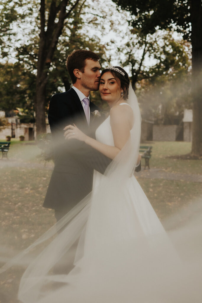 bride and groom posing for wedding portraits