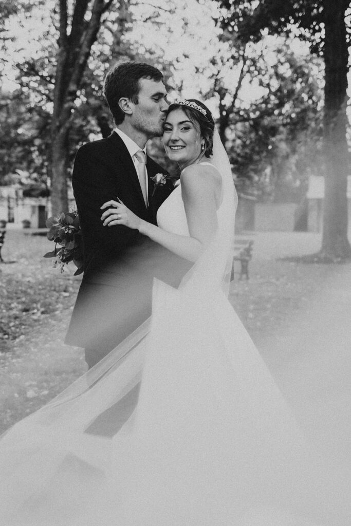 bride and groom posing for wedding portraits