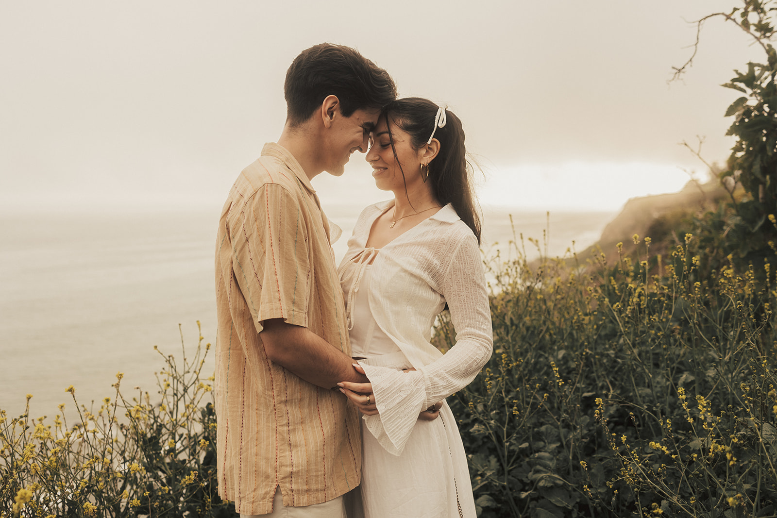 couple posing for their elopement photos in a costa rica field
