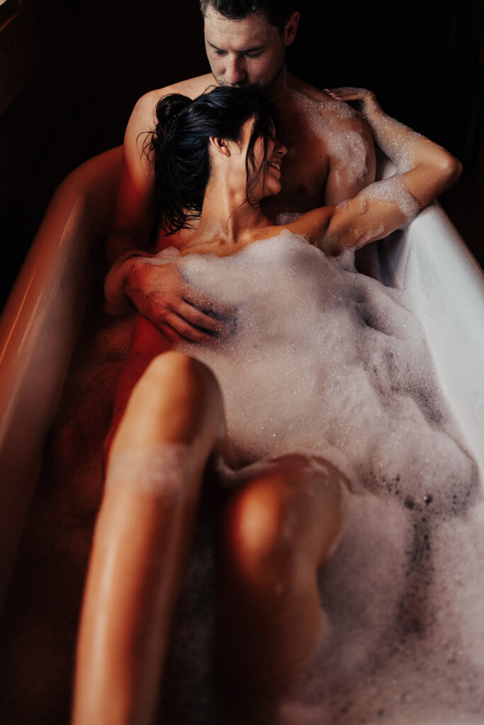 couple posing in a bubble bath