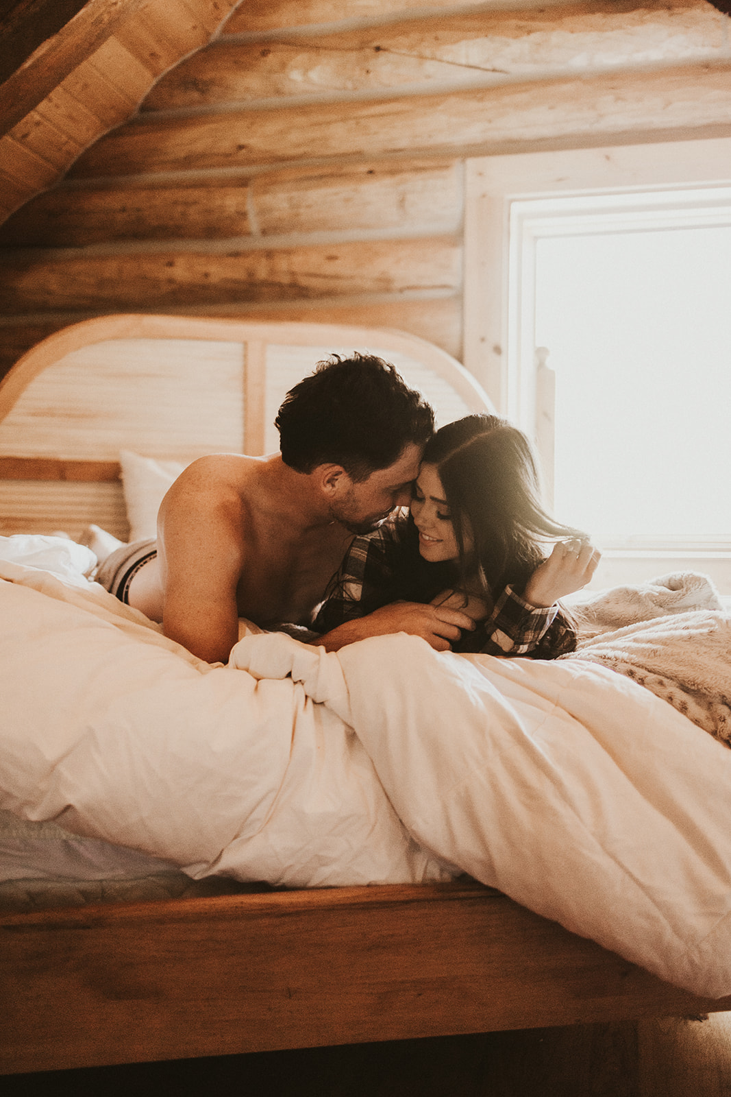 couple posing in a cabin for a photoshoot