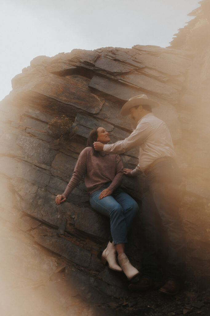 beautiful picture of the couple looking at each other with the sunset in the background 