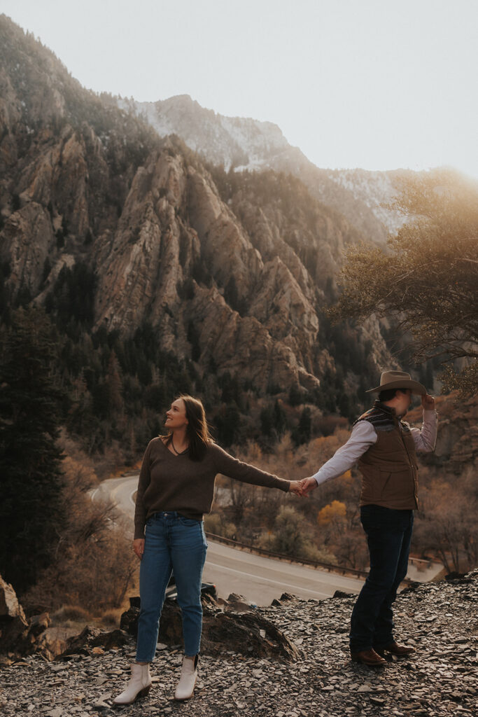 couple holding hands at storm mountain in Utah