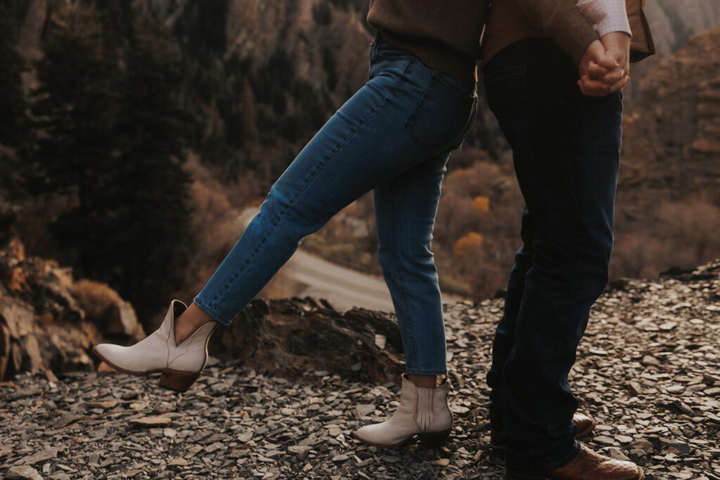 close up shot of the couples feet on the mountain