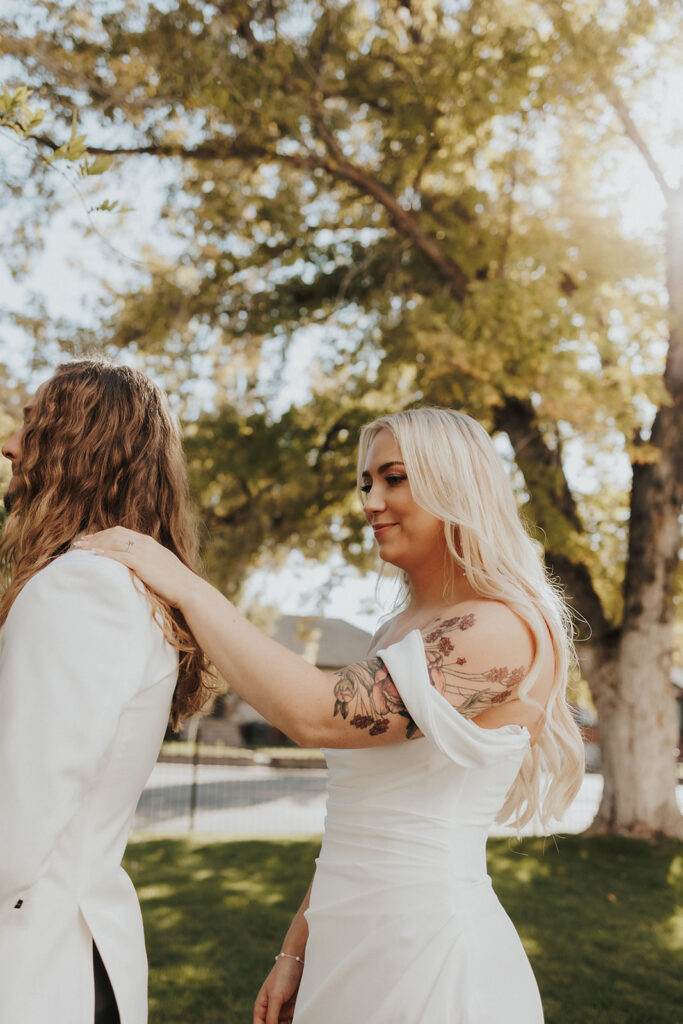 Bride touching the Grooms shoulder for their first look at their intimate wedding at La Capella