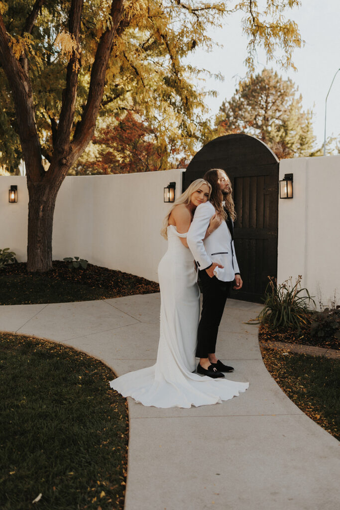 Bride hugging the groom from the back