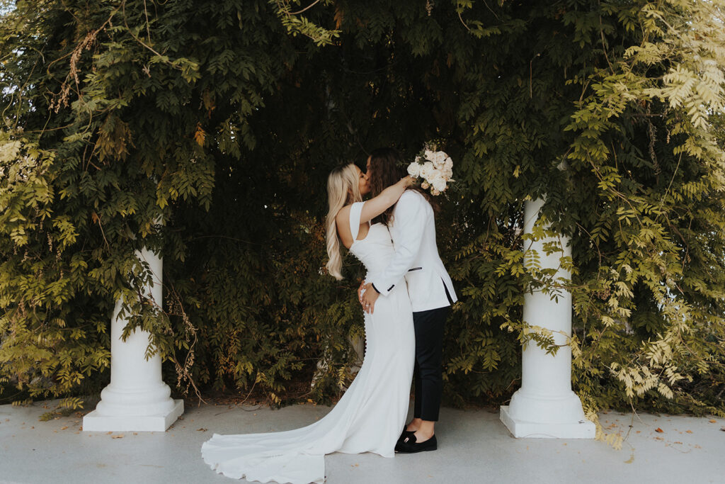 Bride and Groom kissing each other after their intimate wedding