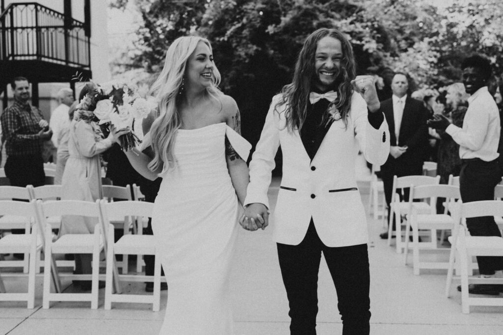 groom excited that he is married. excited walking down the isle.