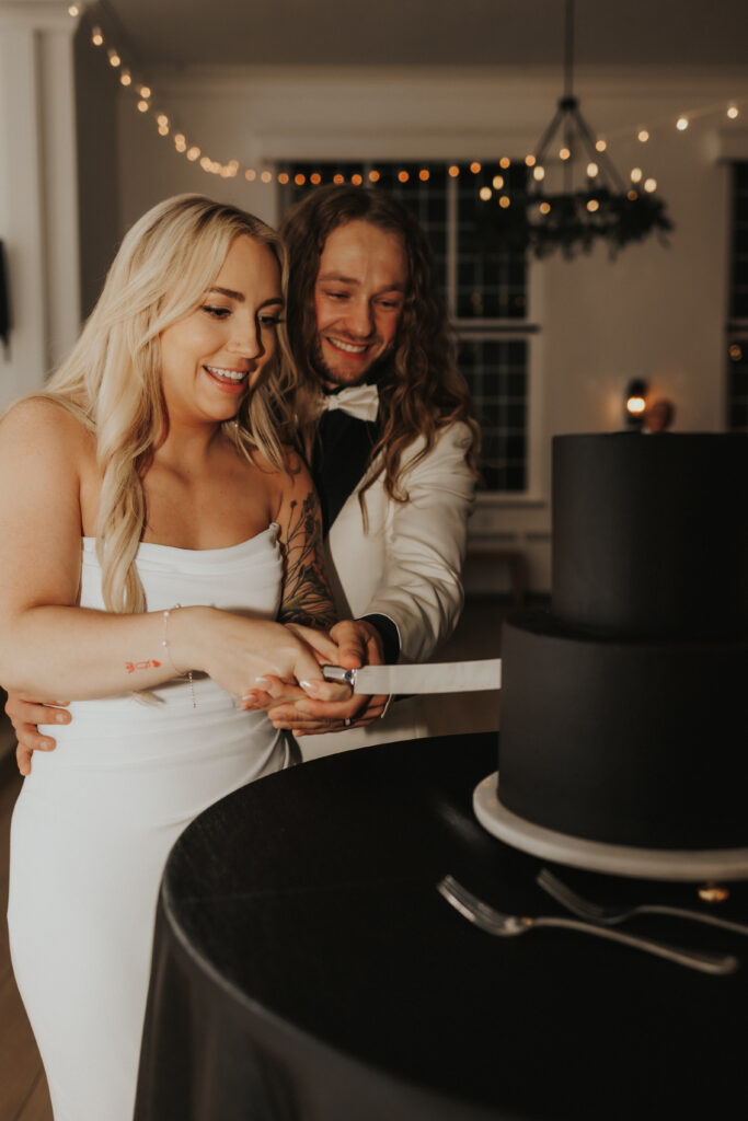 bride and groom cutting the cake together