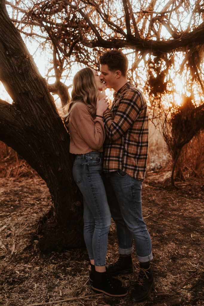 newly engaged couple kissing at their adventurous engagement session 