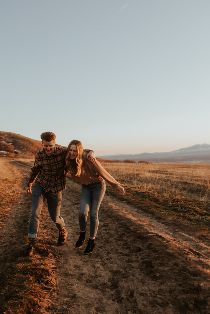 couple walking around the park during their adventurous engagement session 