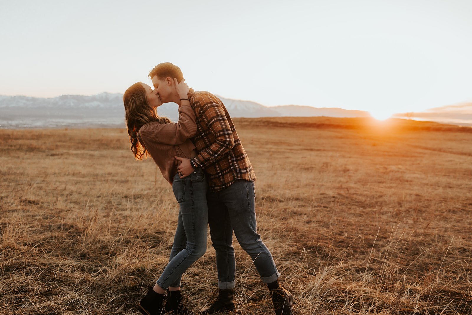 couple kissing during sunset