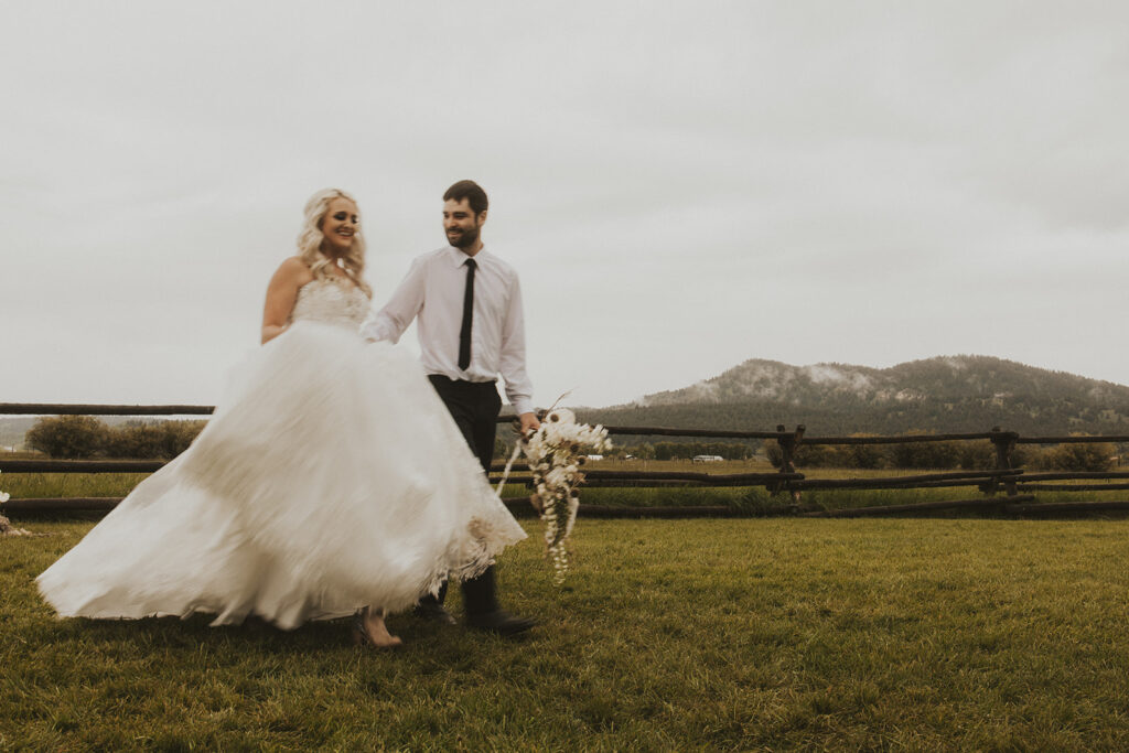 bride and groom holding hands walking around their wedding venue