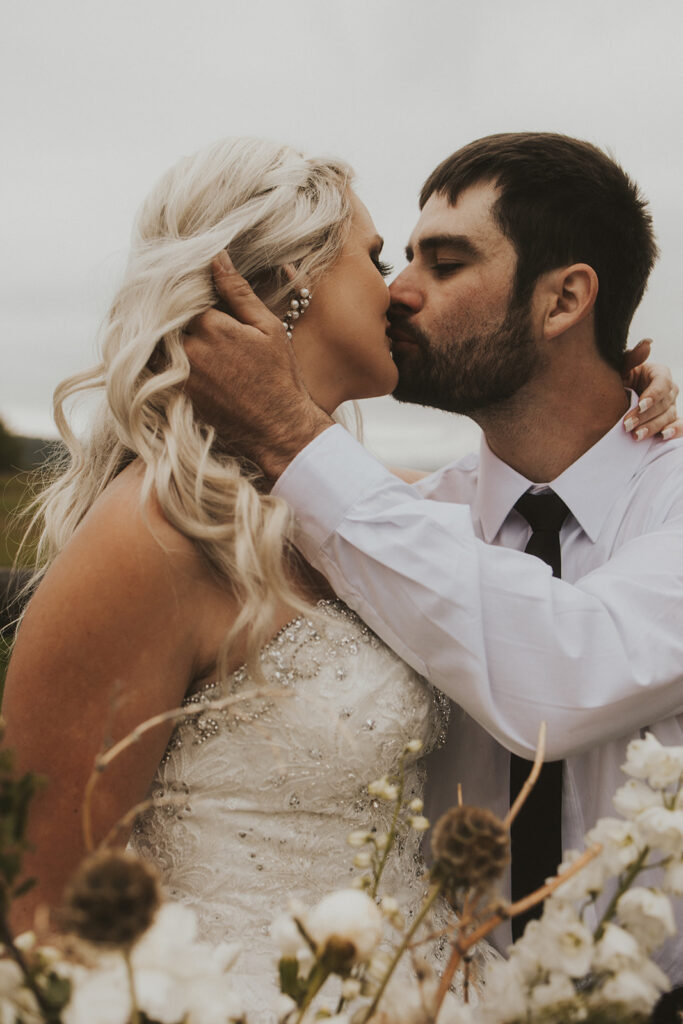 newly married couple kissing 
