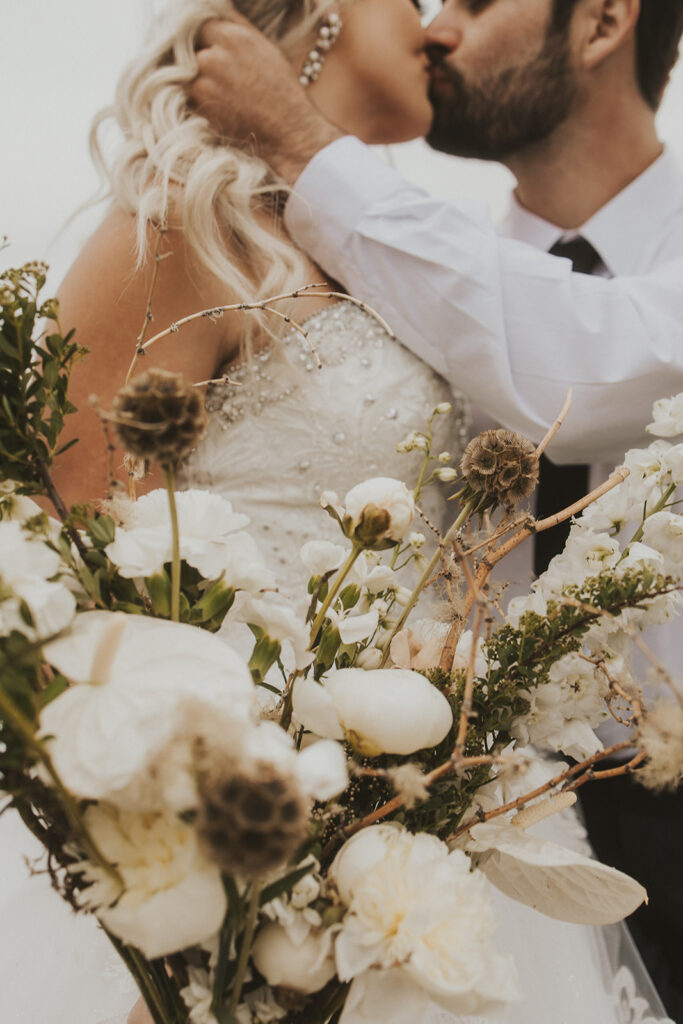 bride and groom kissing at their intimate western wedding 