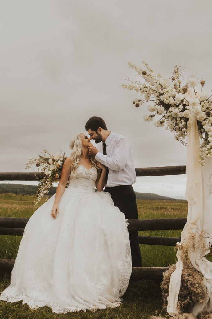 bride and groom smiling at each other 
