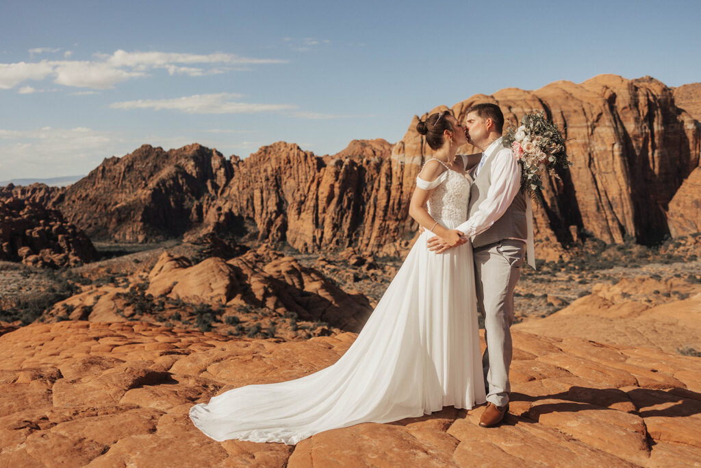 newly married couple kissing after their ceremony
