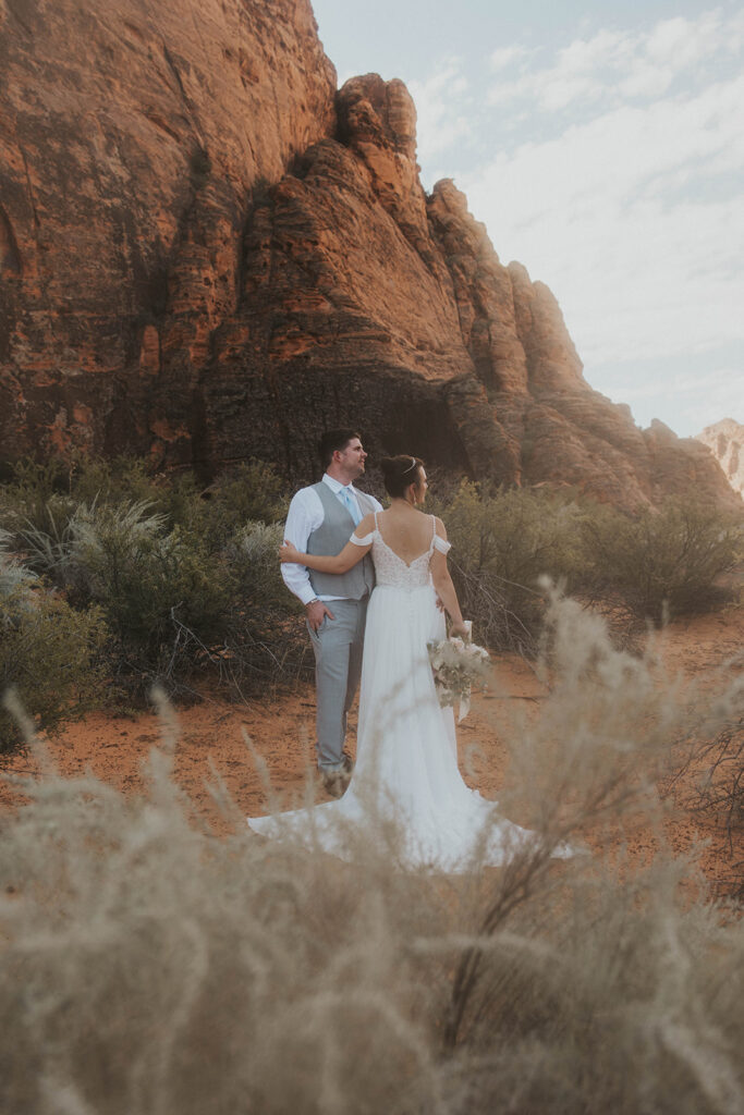 bride and groom hugging - how to elope in moab 