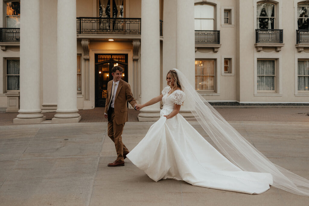 cute couple walking around their wedding venue 