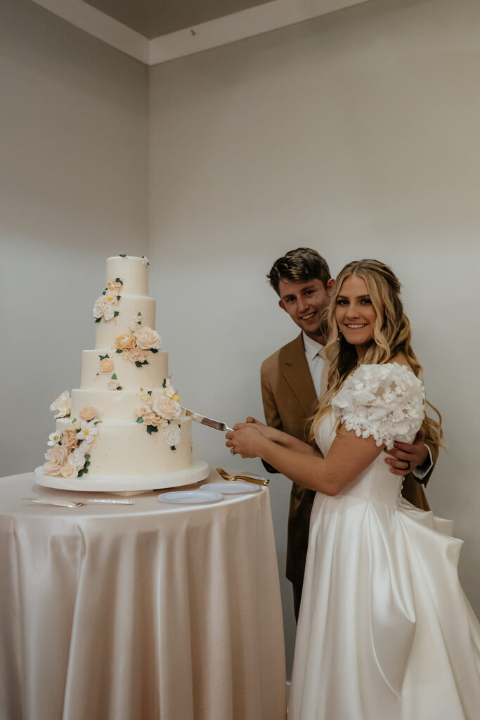 newlyweds cutting their wedding cake 