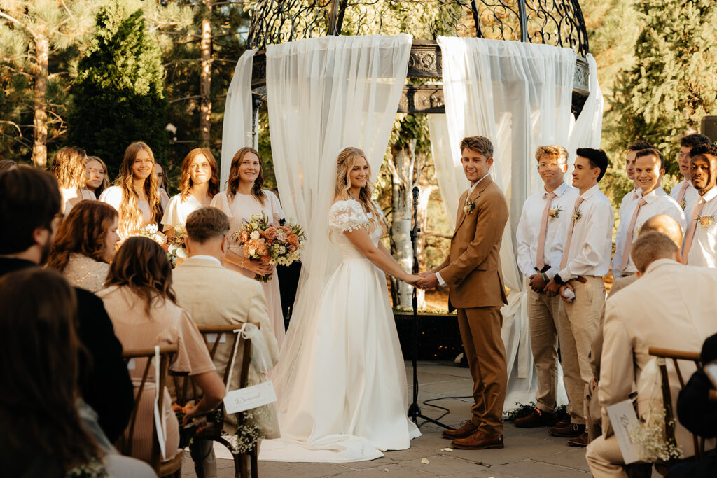 bride and groom holding hands at their ceremony