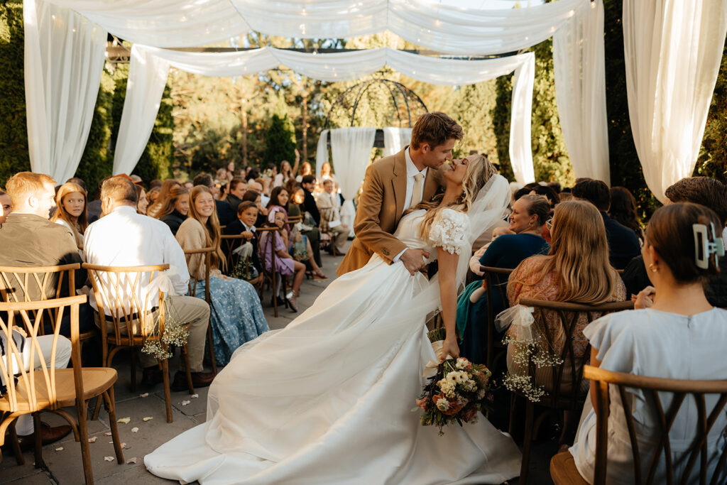 cute couple kissing after their ceremony 