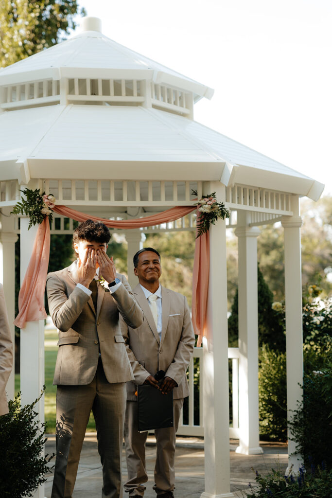 groom emotional watching the bride walk down the aisle 