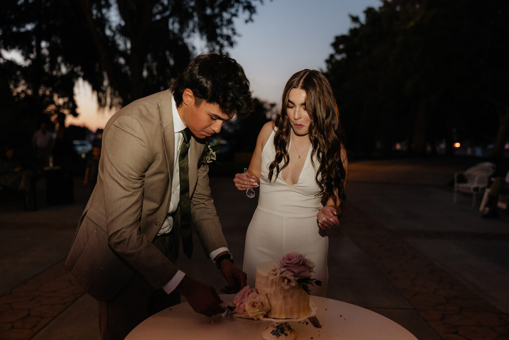 newly married couple trying their wedding cake 