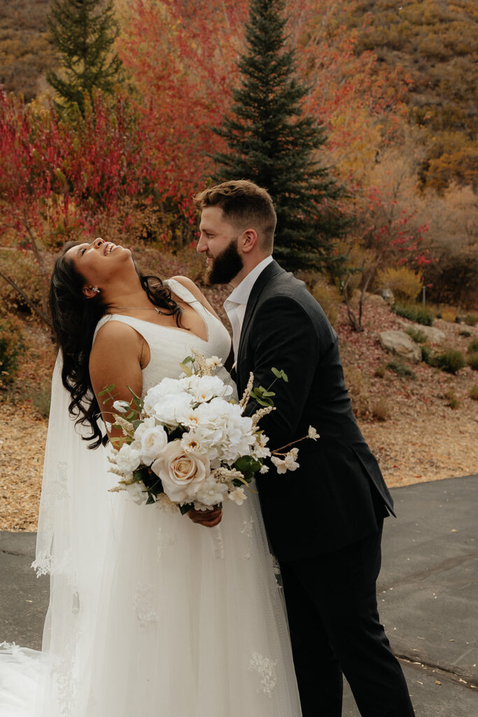 cute picture of the bride and groom laughing with each other