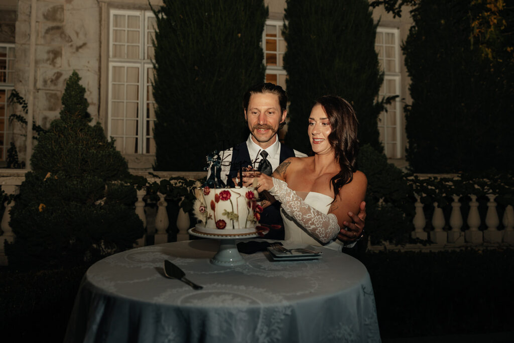 beautiful picture of the newlyweds cutting their wedding cake