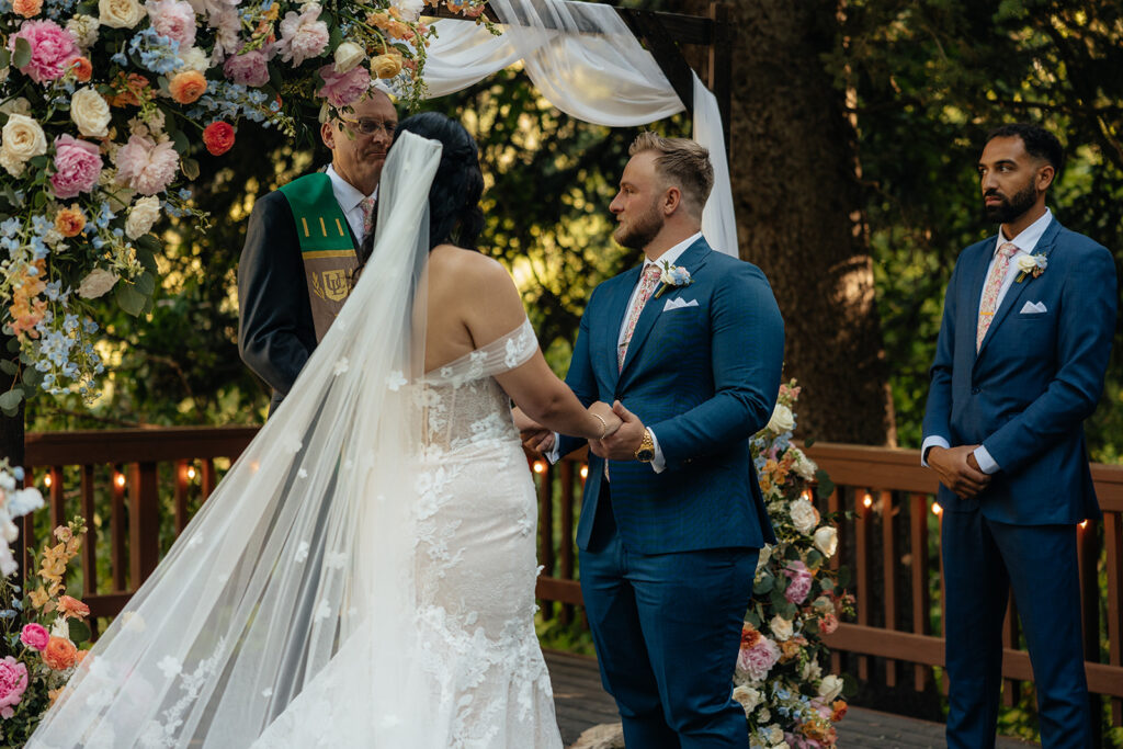 bride and groom holding hands during their wedding ceremony
