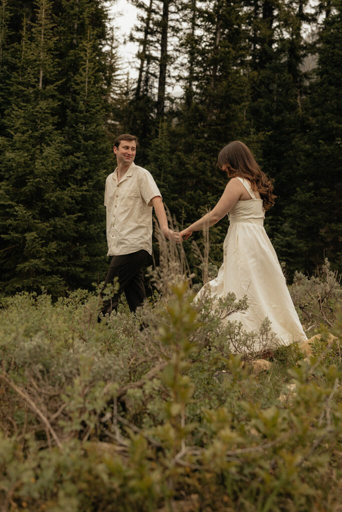 newly engaged couple smiling at each other during their photoshoot