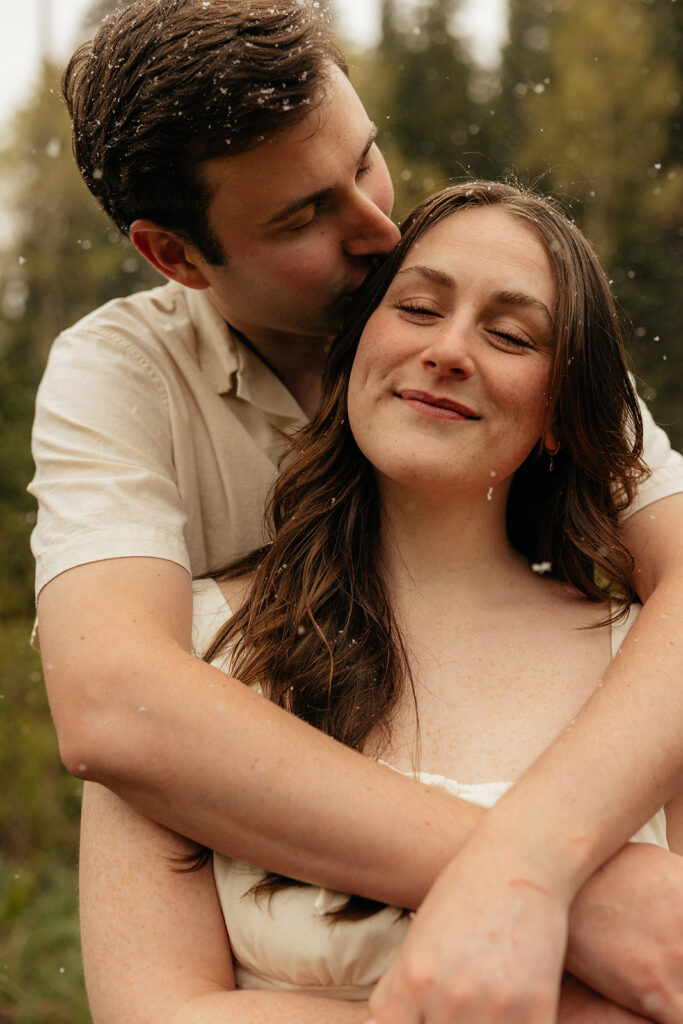 fiance kissing his fiance on the cheek