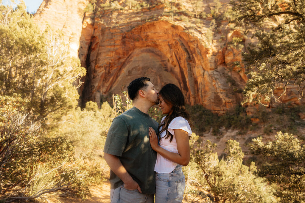 fiance kissing his fiance on the forehead