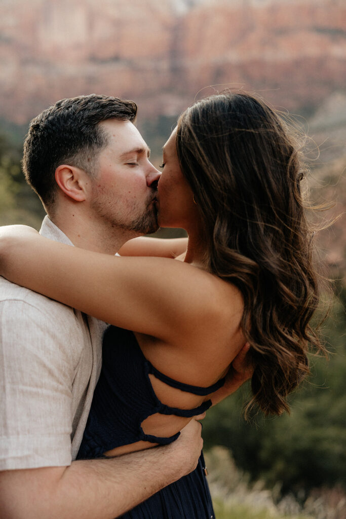 cute picture of the newly engaged couple kissing