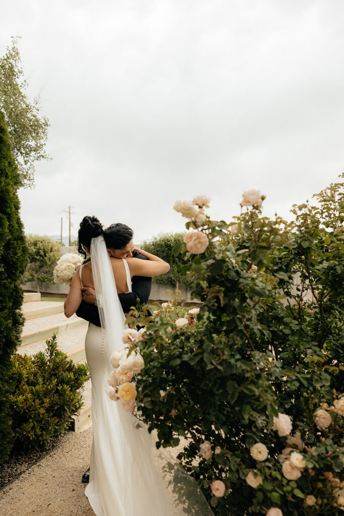 beautiful picture of the bride and groom hugging after their first look