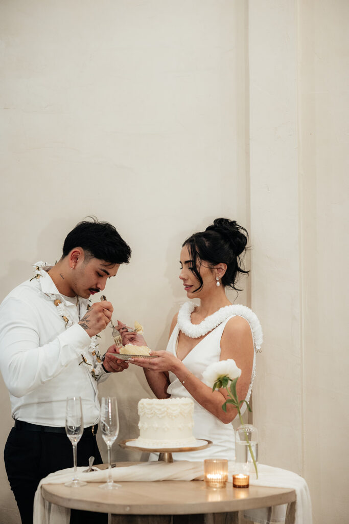 newly married couple trying their wedding cake