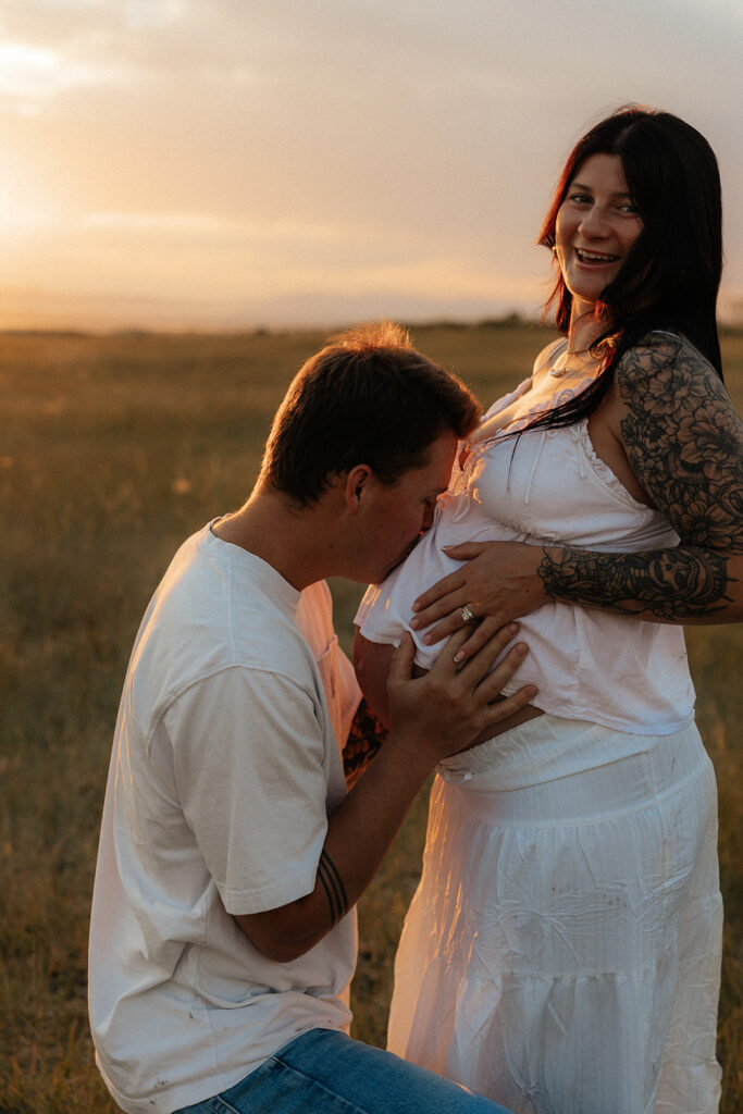cute picture of the soon to be parents smiling at each other