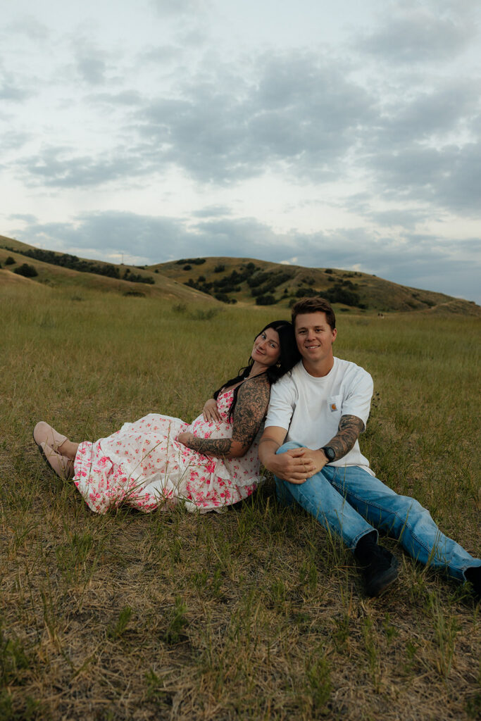 soon to be parents posing for the camera during their photoshoot